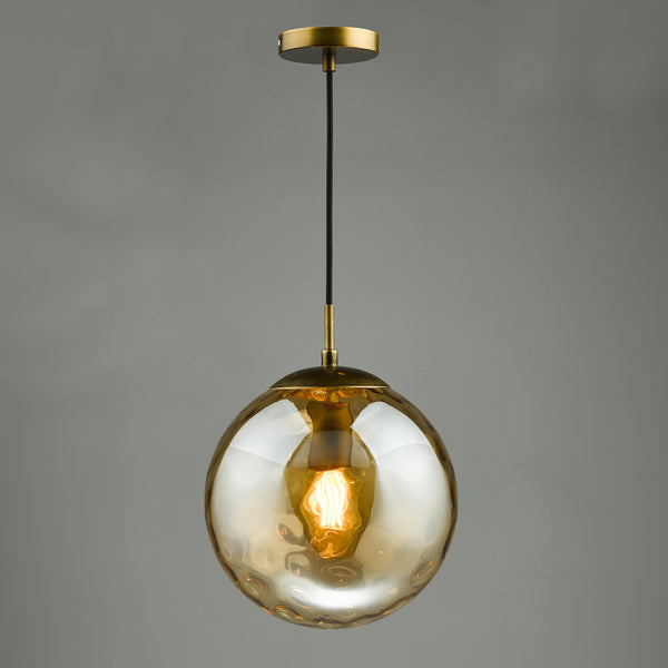 Textured amber glass globe pendant light with a brass fixture and exposed filament bulb.