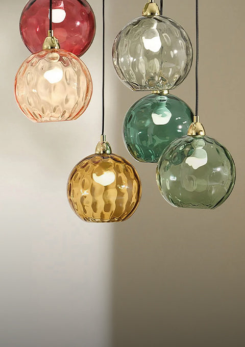 Cluster of five multicolored glass globe pendant lights with brass hardware
