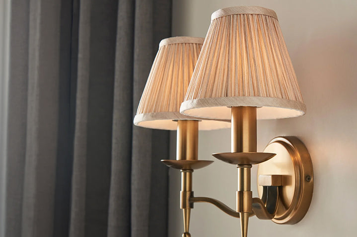 Double wall sconce with brass finish and pleated fabric shades