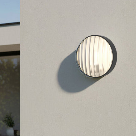 Round outdoor wall light with a ribbed glass diffuser