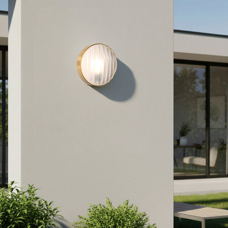 Astro Montreal Round 300 IP44 Exterior Wall Light in Brushed Brass on a white wall
