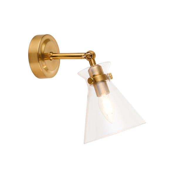 Brass wall sconce with a clear, conical glass shade and an exposed bulb, angled downwards.