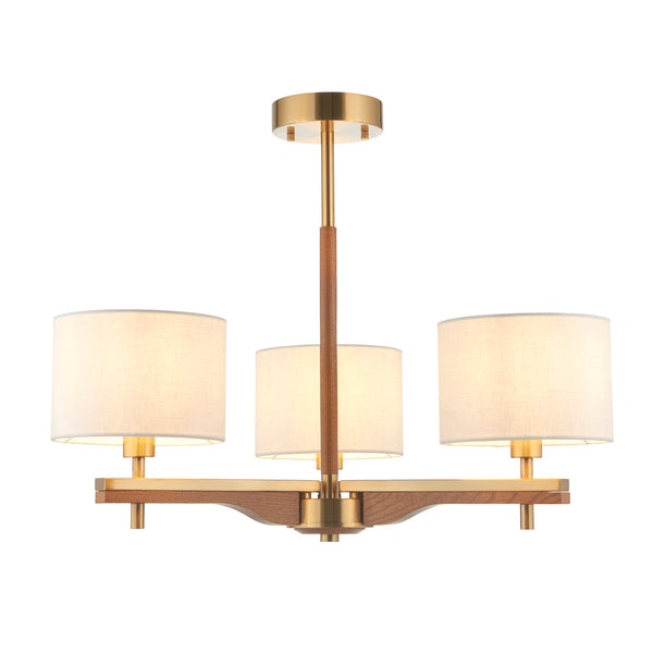 Modern chandelier with three white fabric shades, brass accents, and a wooden central rod and base.