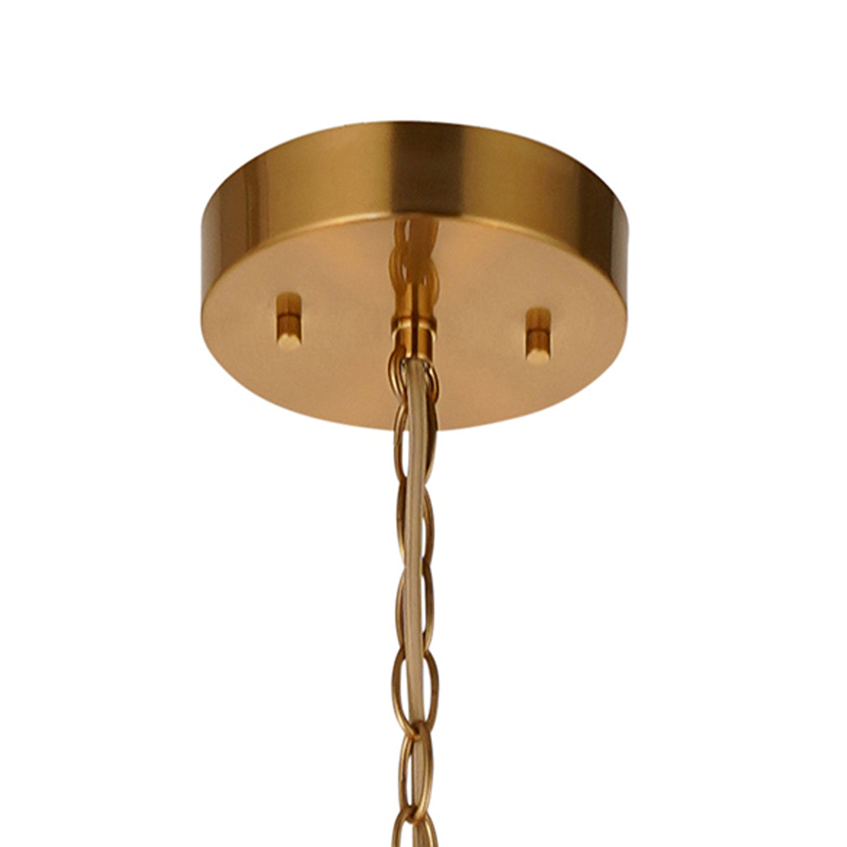 Close-up of a gold ceiling canopy with a matching chain and electrical cord, against a white background.