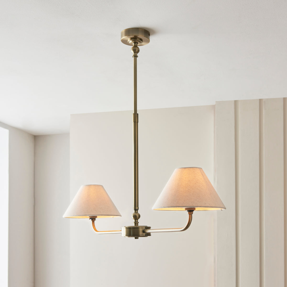 Lille Twin Light Linear Pendant in Antique Brass with Tapered Natural Linen Shades