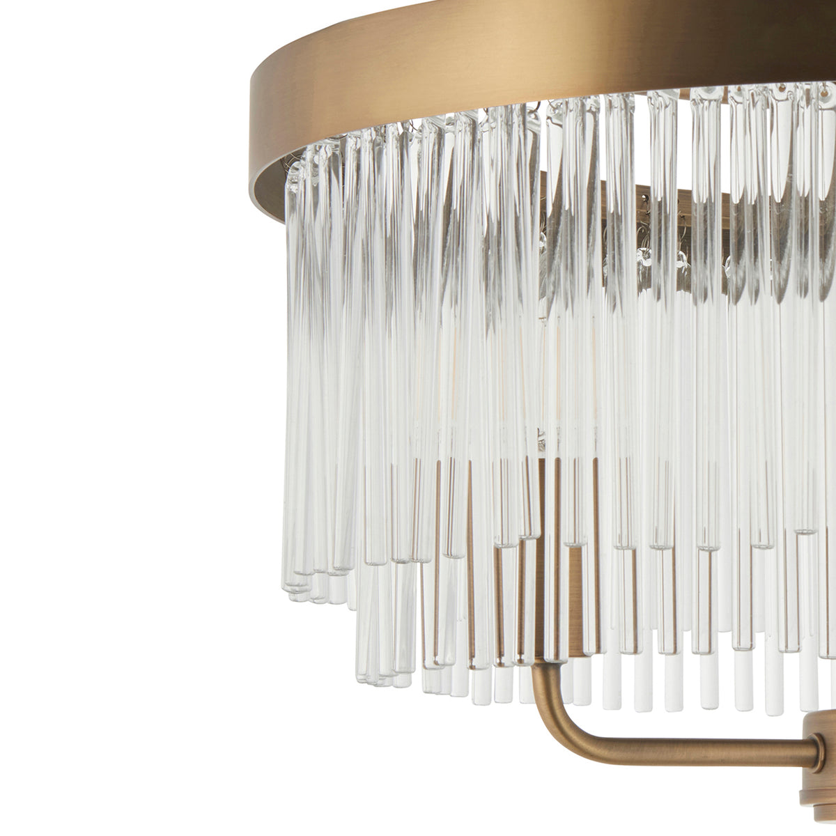 Close-up of a modern brass chandelier with clear glass rods hanging in two tiers.