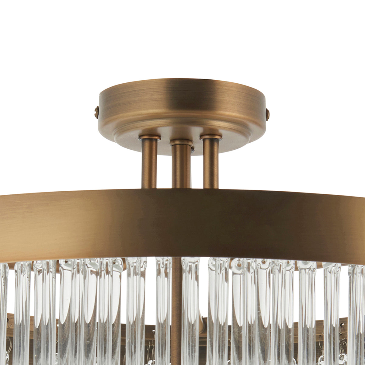 Close-up of a bronze ceiling light fixture with clear glass rods hanging from a circular frame.