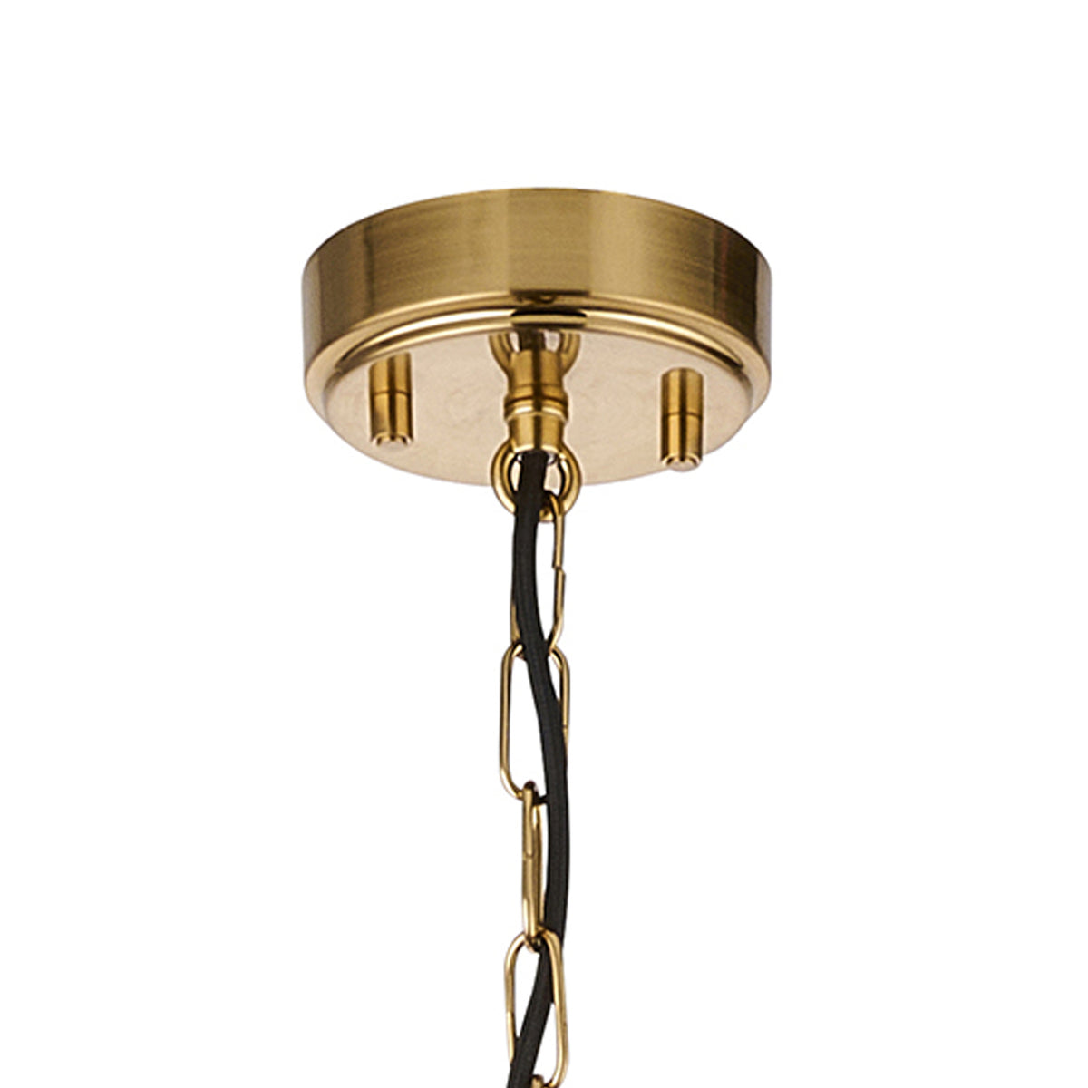 Close-up of a brass ceiling rose with a black cable and brass chain extending downwards.