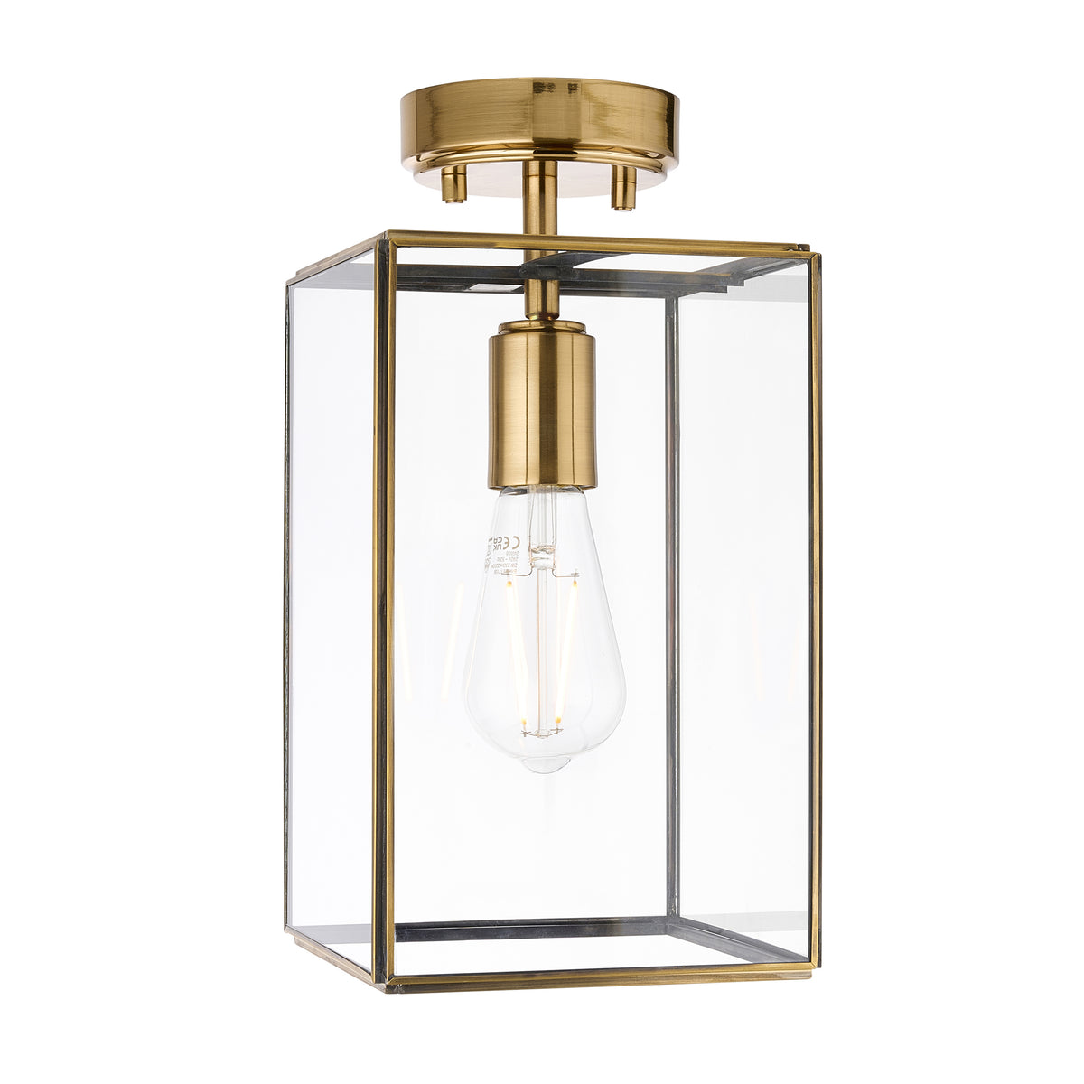 A brass and glass semi-flush mount ceiling light with an exposed Edison bulb.