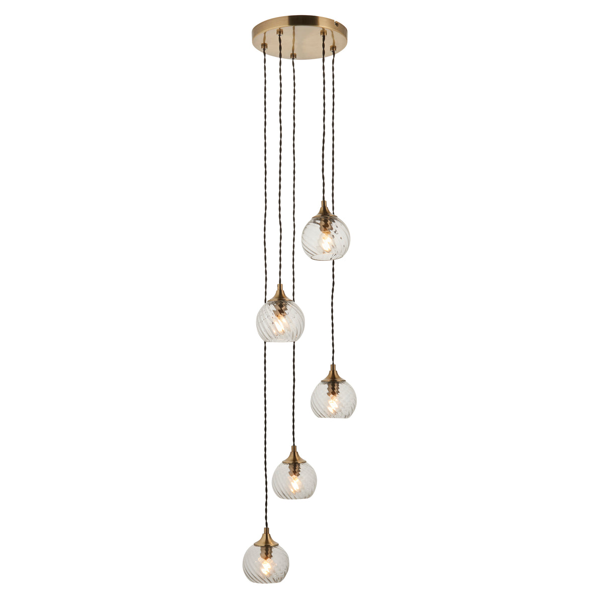 Five clear glass pendant lights with brass accents hang from a round brass ceiling plate.