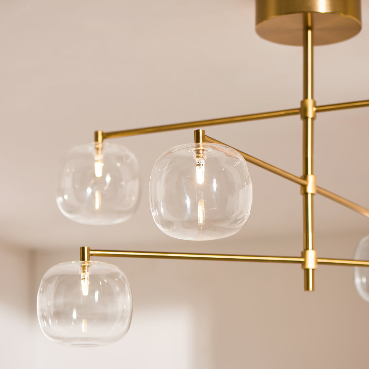 Oslo Six Light Pendant in Brushed Aged Brass with Clear Glass Shades