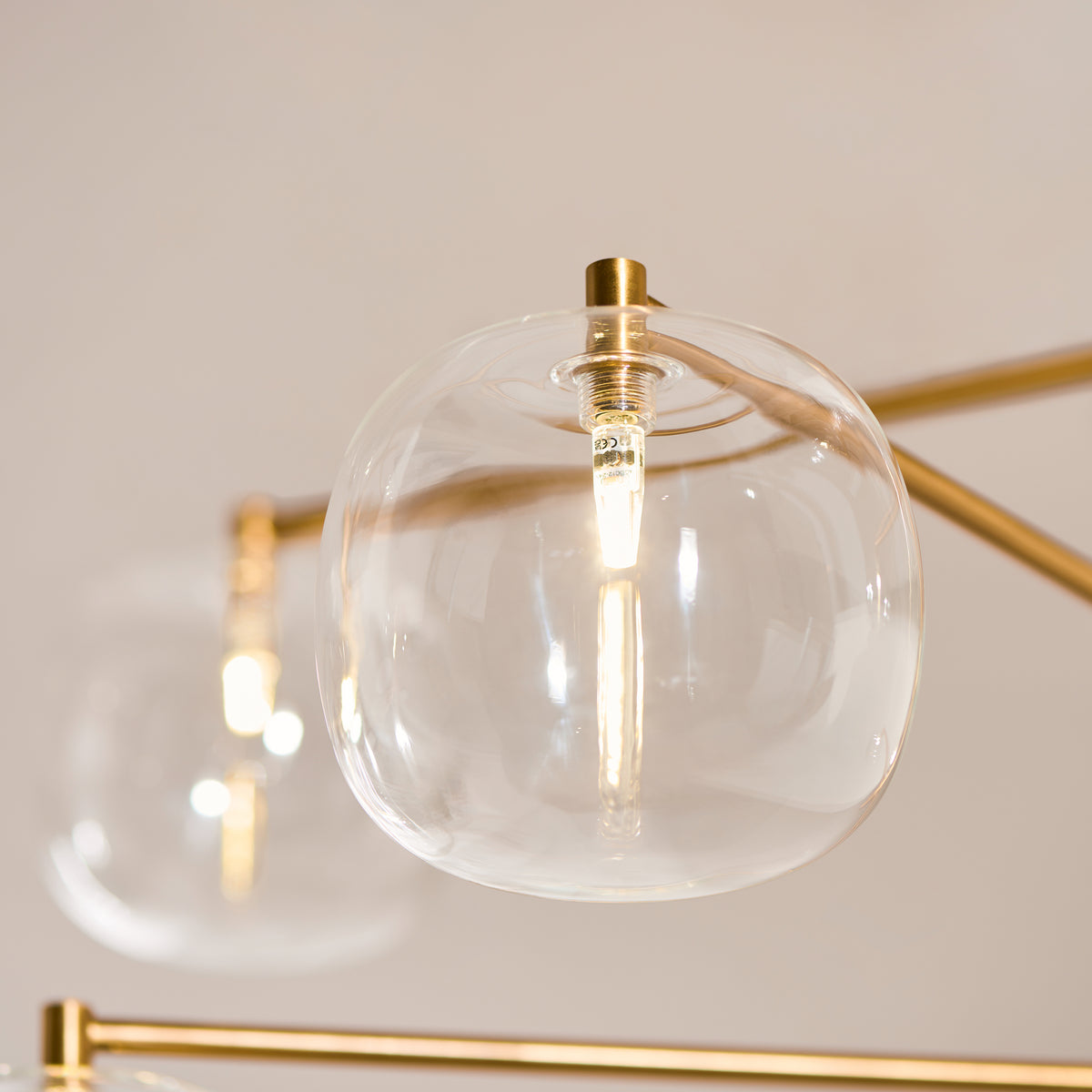 Oslo Six Light Pendant in Brushed Aged Brass with Clear Glass Shades
