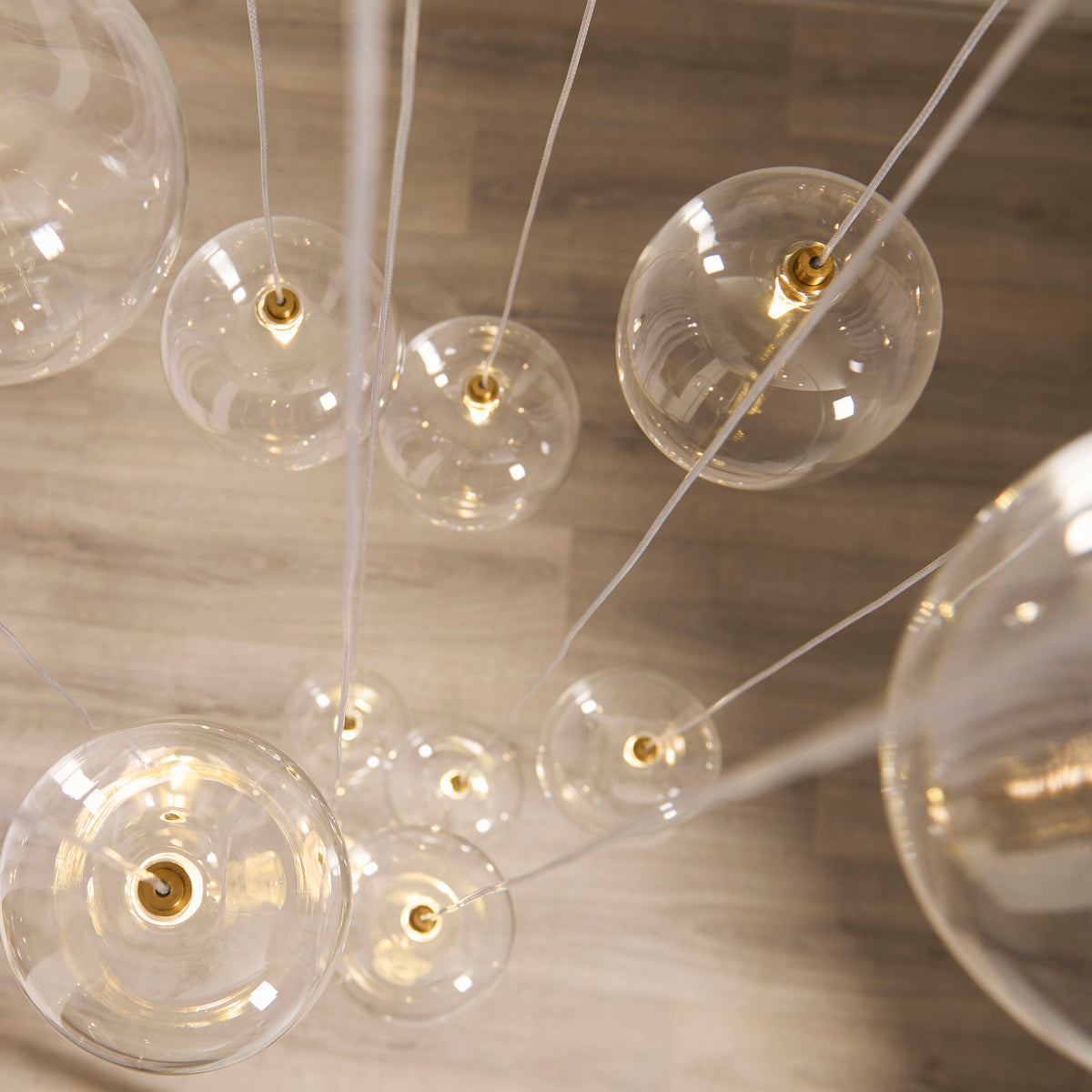Oslo Twelve Light Cluster Pendant in Brushed Aged Brass with Clear Glass Shades