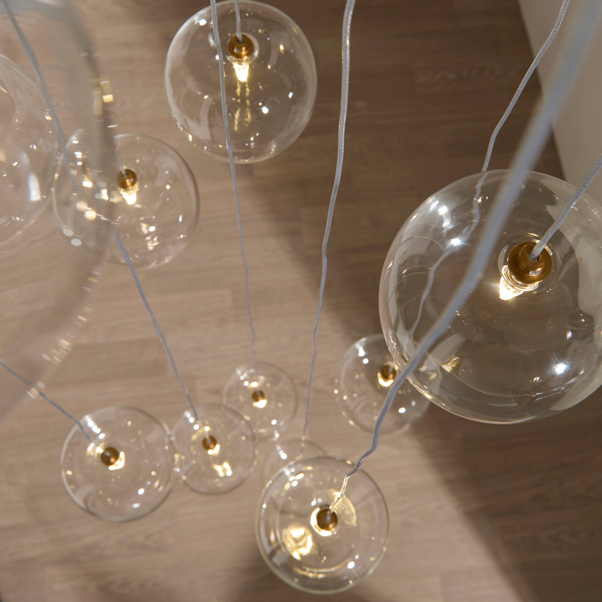 Oslo Twelve Light Cluster Pendant in Brushed Aged Brass with Clear Glass Shades