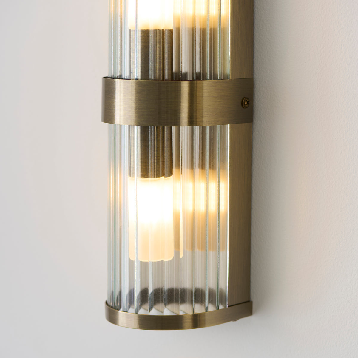 Ridgeton IP44 Twin Wall Light in Antique Brass with Clear Ribbed Glass