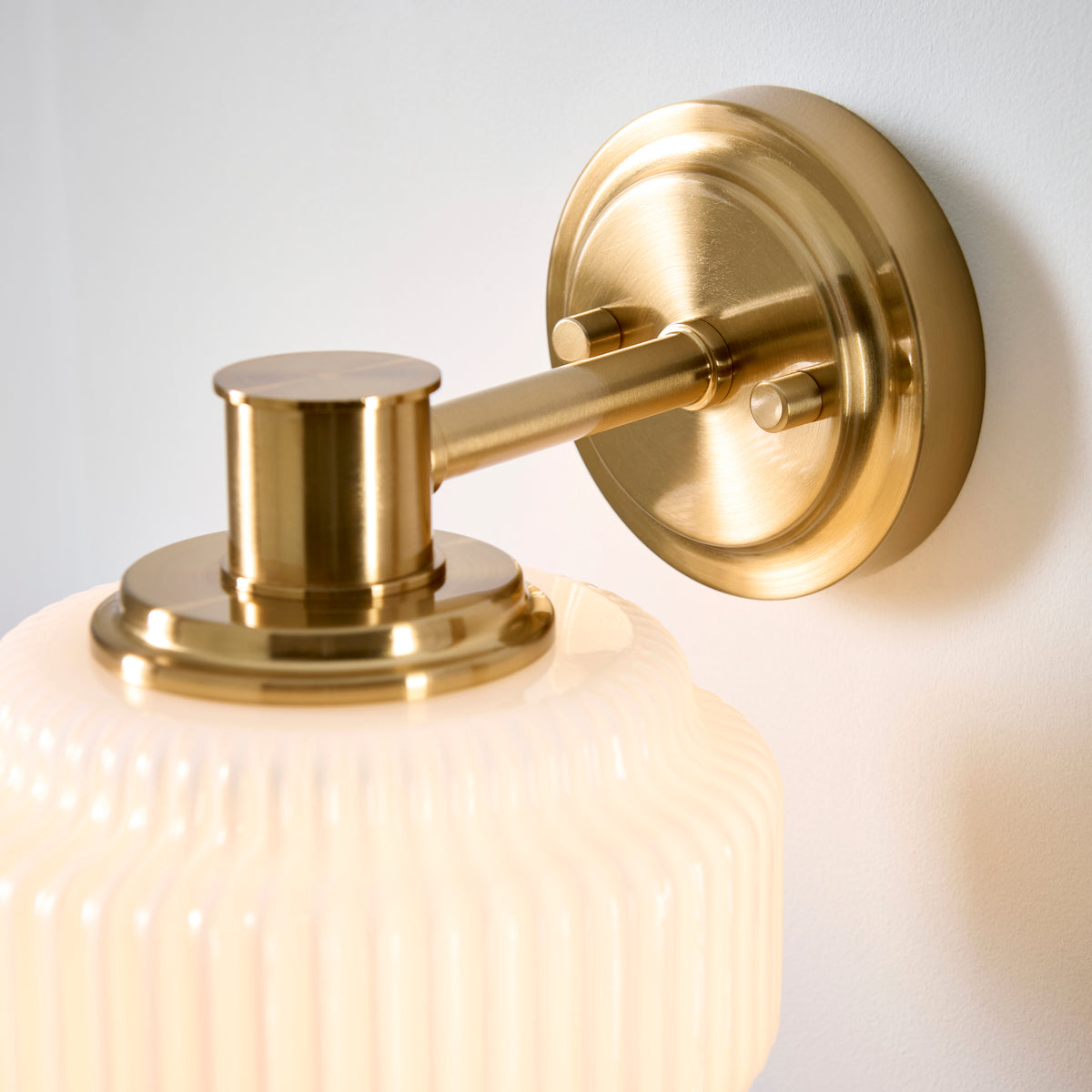 Evora Wall Light in Brushed Aged Brass with Gloss Opal Ribbed Glass