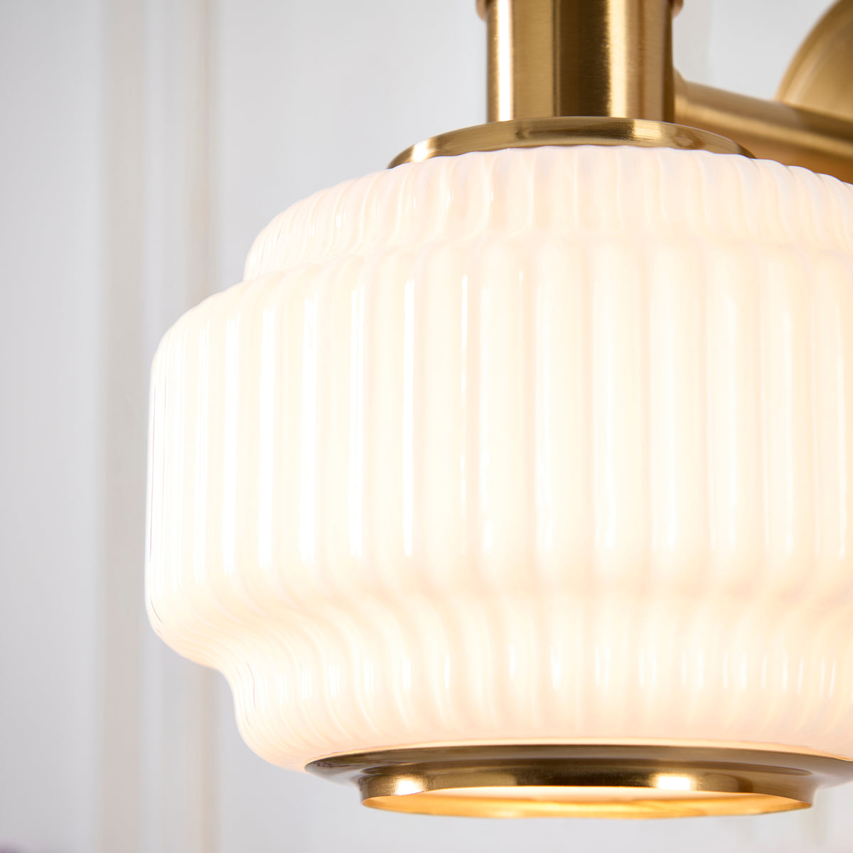 Evora Wall Light in Brushed Aged Brass with Gloss Opal Ribbed Glass