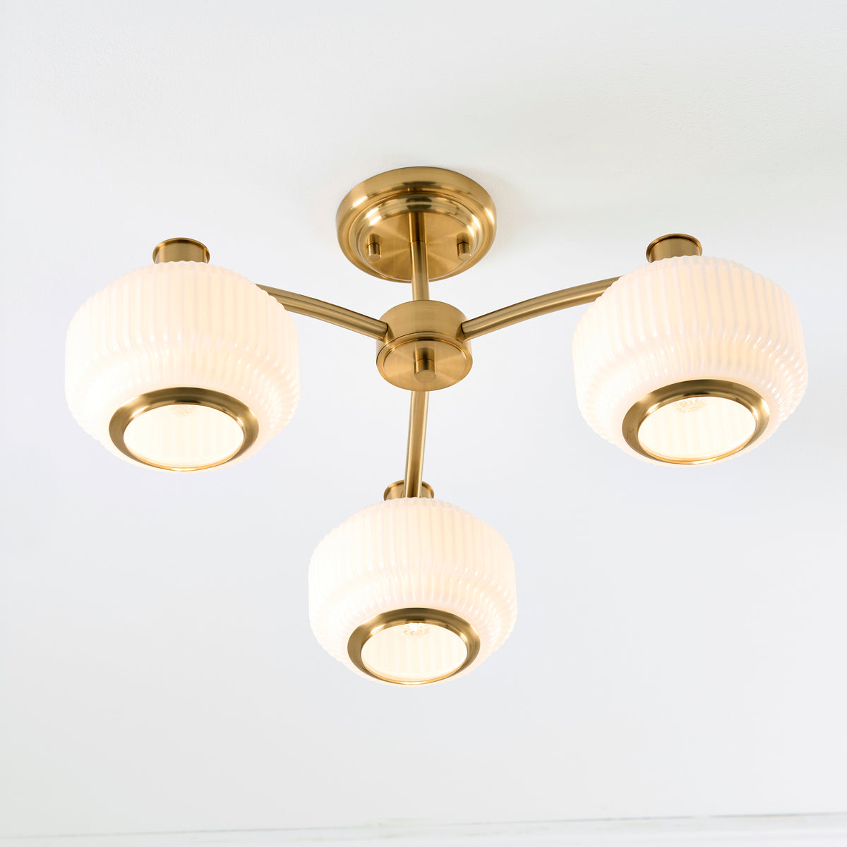 Evora Three Arm Semi Flush in Brushed Aged Brass with Gloss Opal Ribbed Glass Shades