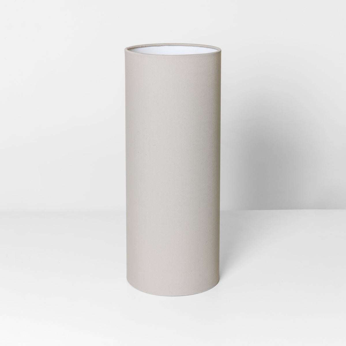 Tall cylindrical lampshade in a neutral beige color