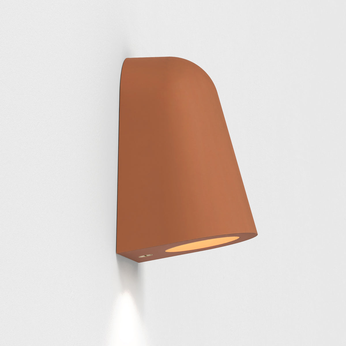 Terracotta wall light with a curved top and a downward-facing light source