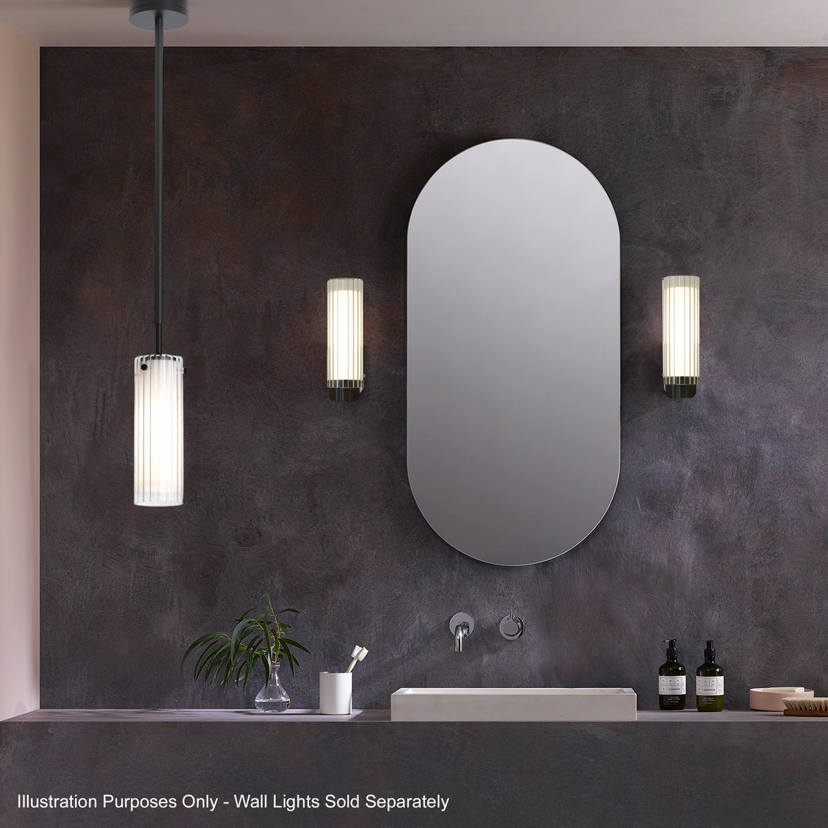 A bathroom with a dark textured wall, a white rectangular sink, and a large oval mirror