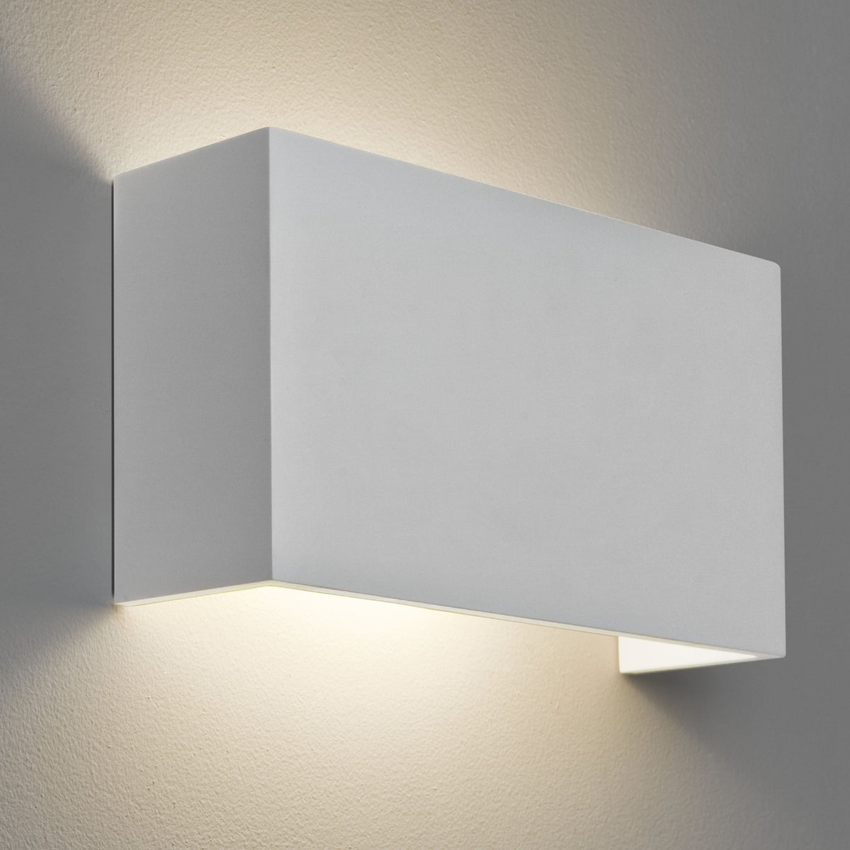 White rectangular wall light with warm light shining upwards and downwards