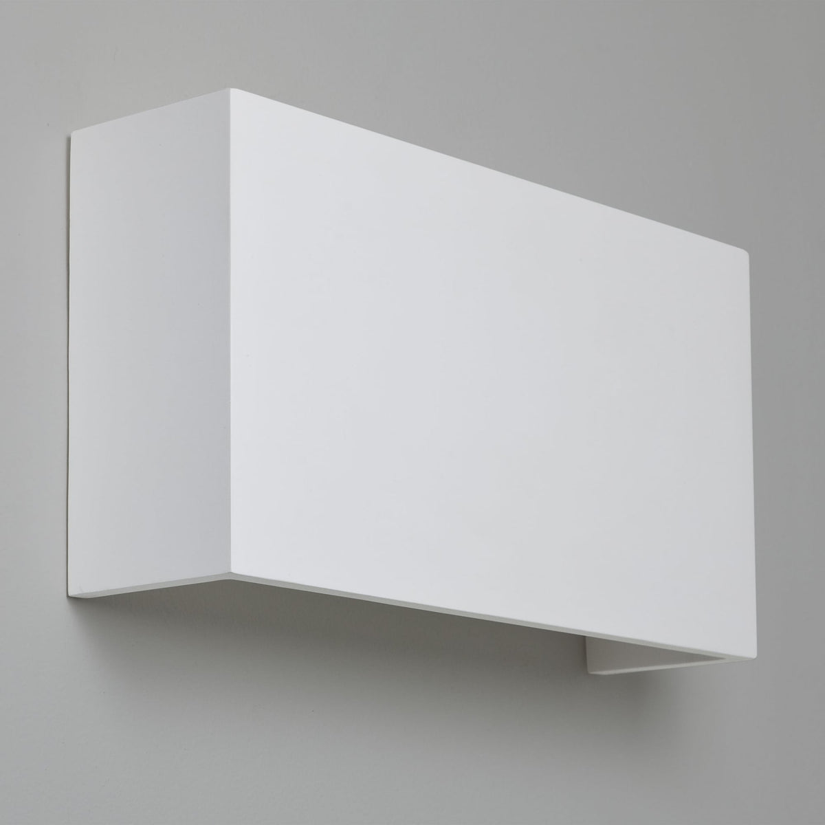 White rectangular wall light with an open bottom, casting light upwards and downwards