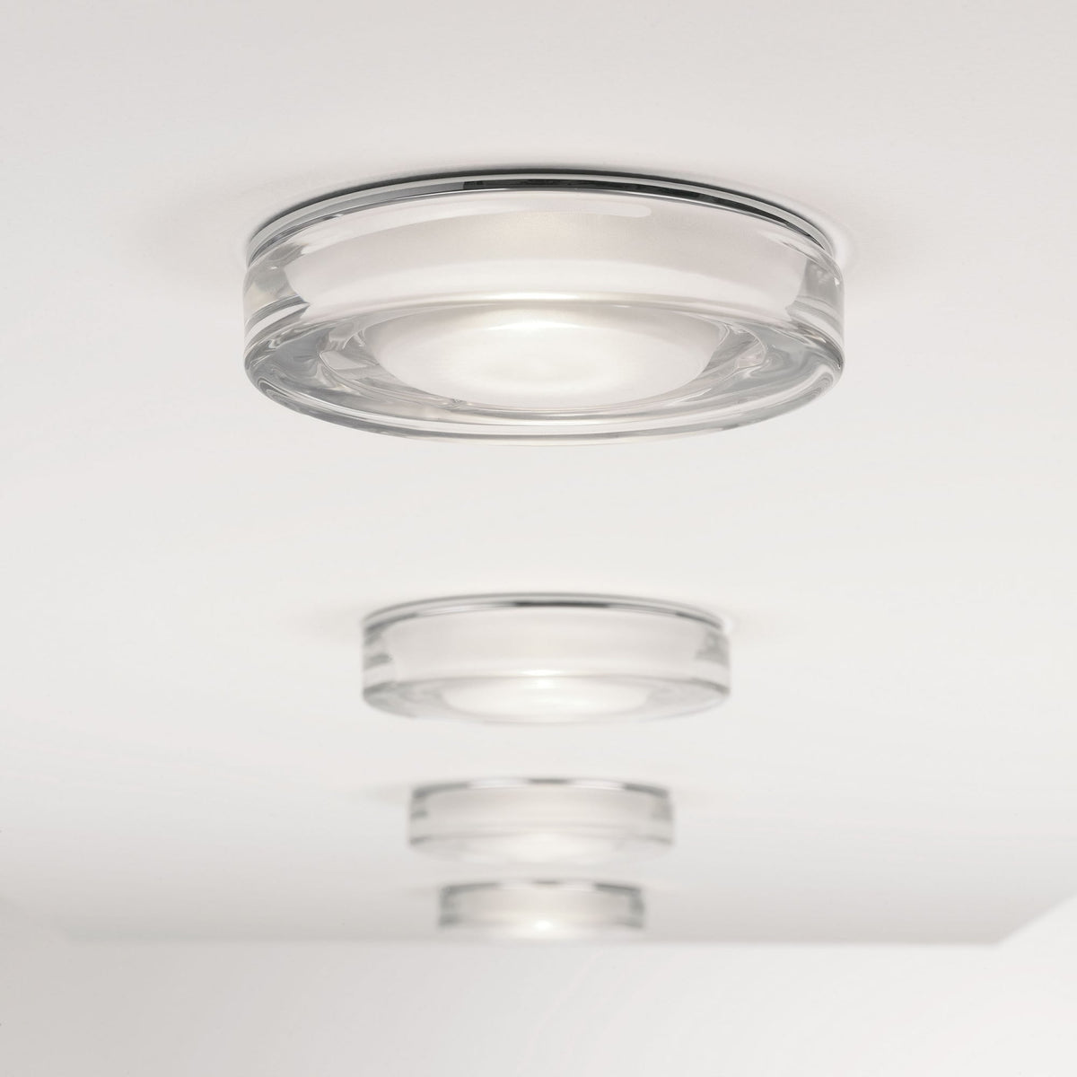 Three round glass ceiling lights with chrome trim