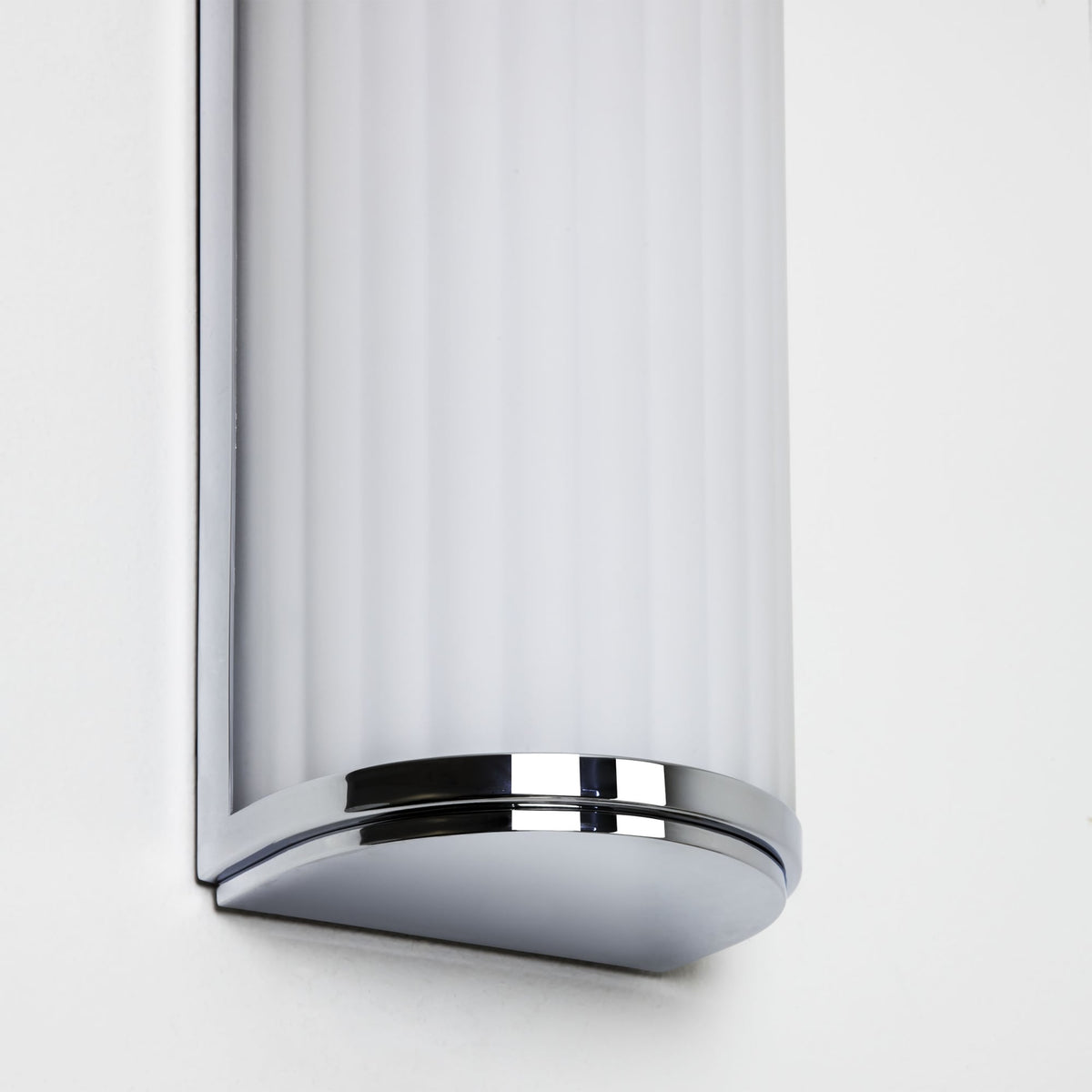 Close up of a chrome and white wall light
