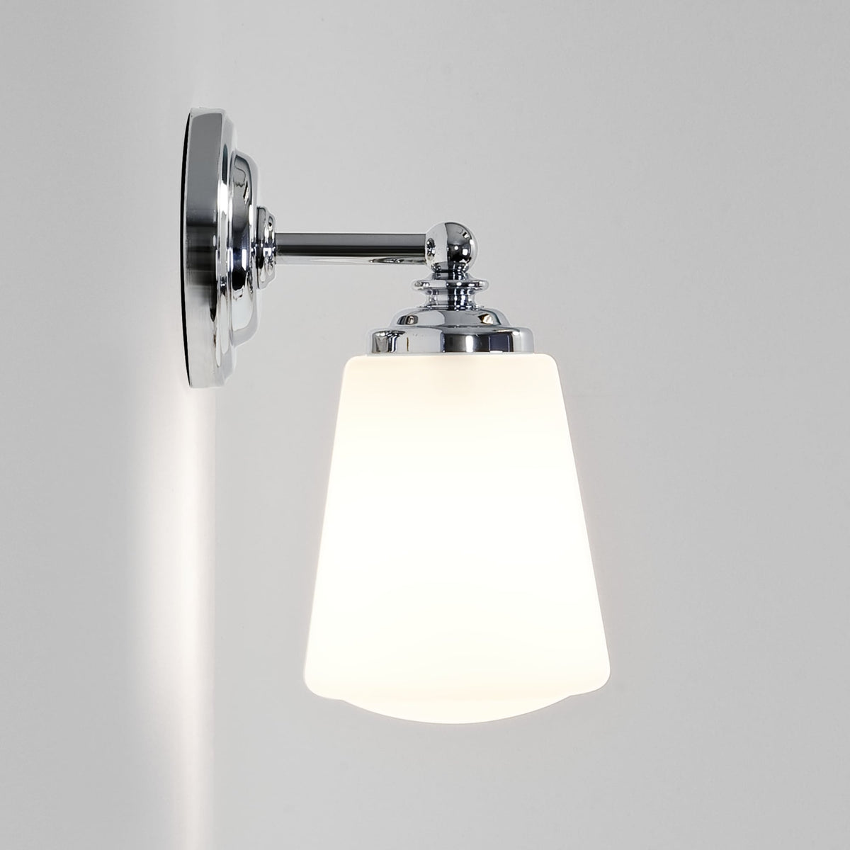 Chrome wall light with a white tapered glass shade