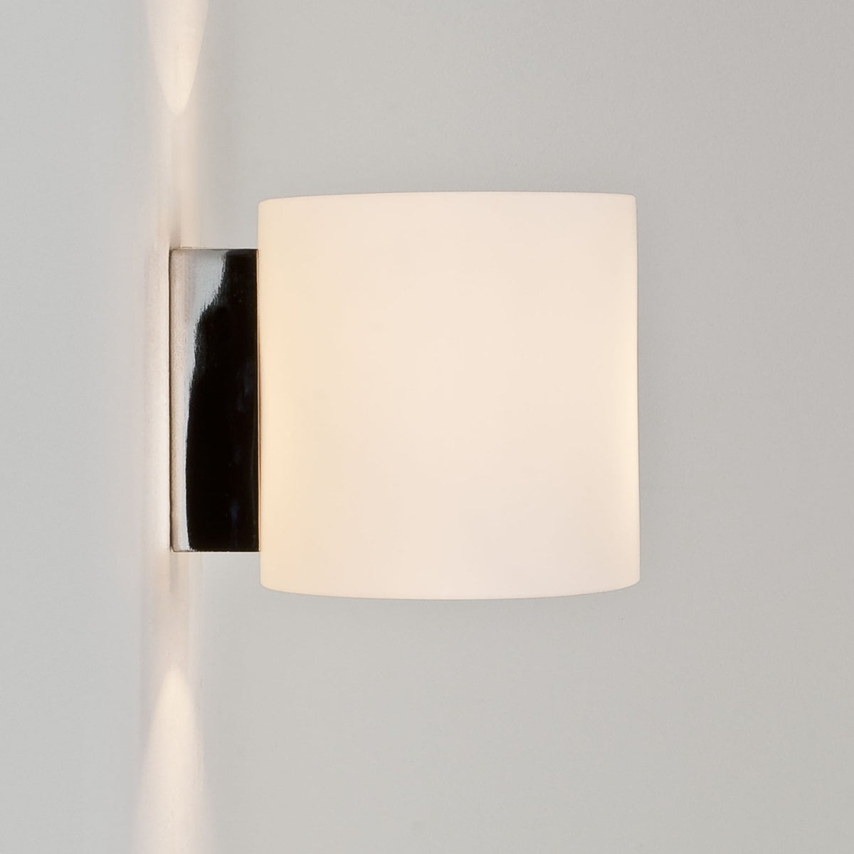 Wall mounted light fixture with a rectangular white shade and a polished chrome base