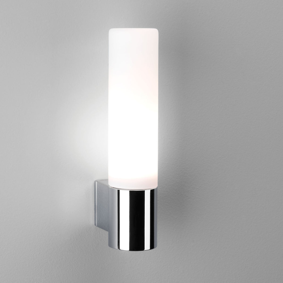 Modern cylindrical wall light with a frosted glass shade and polished chrome base.