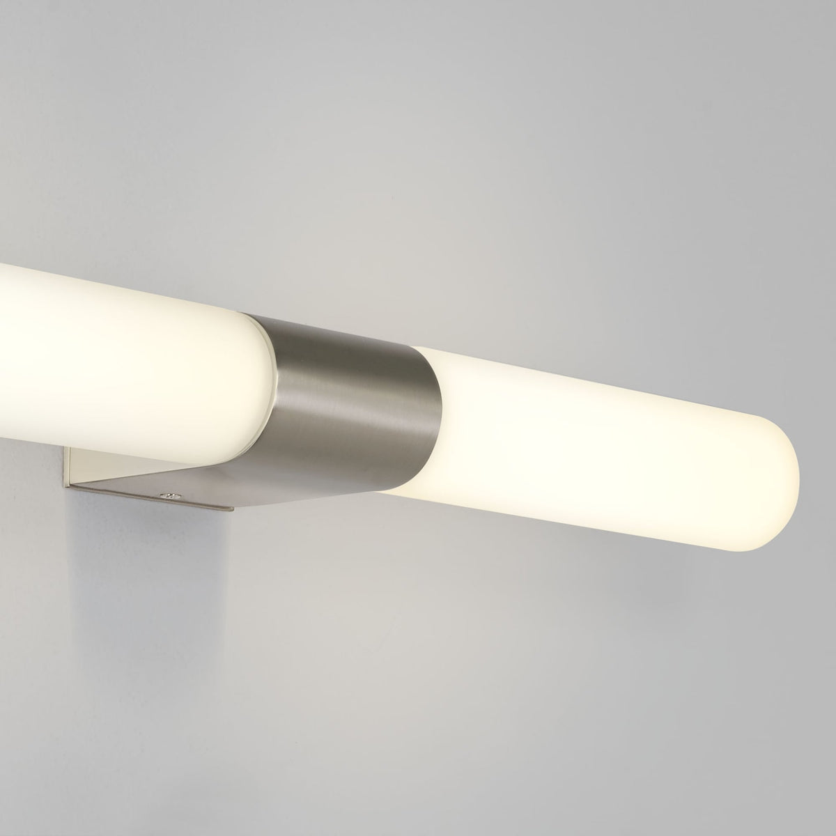 Horizontal cylindrical light fixture with a brushed metal band around the center
