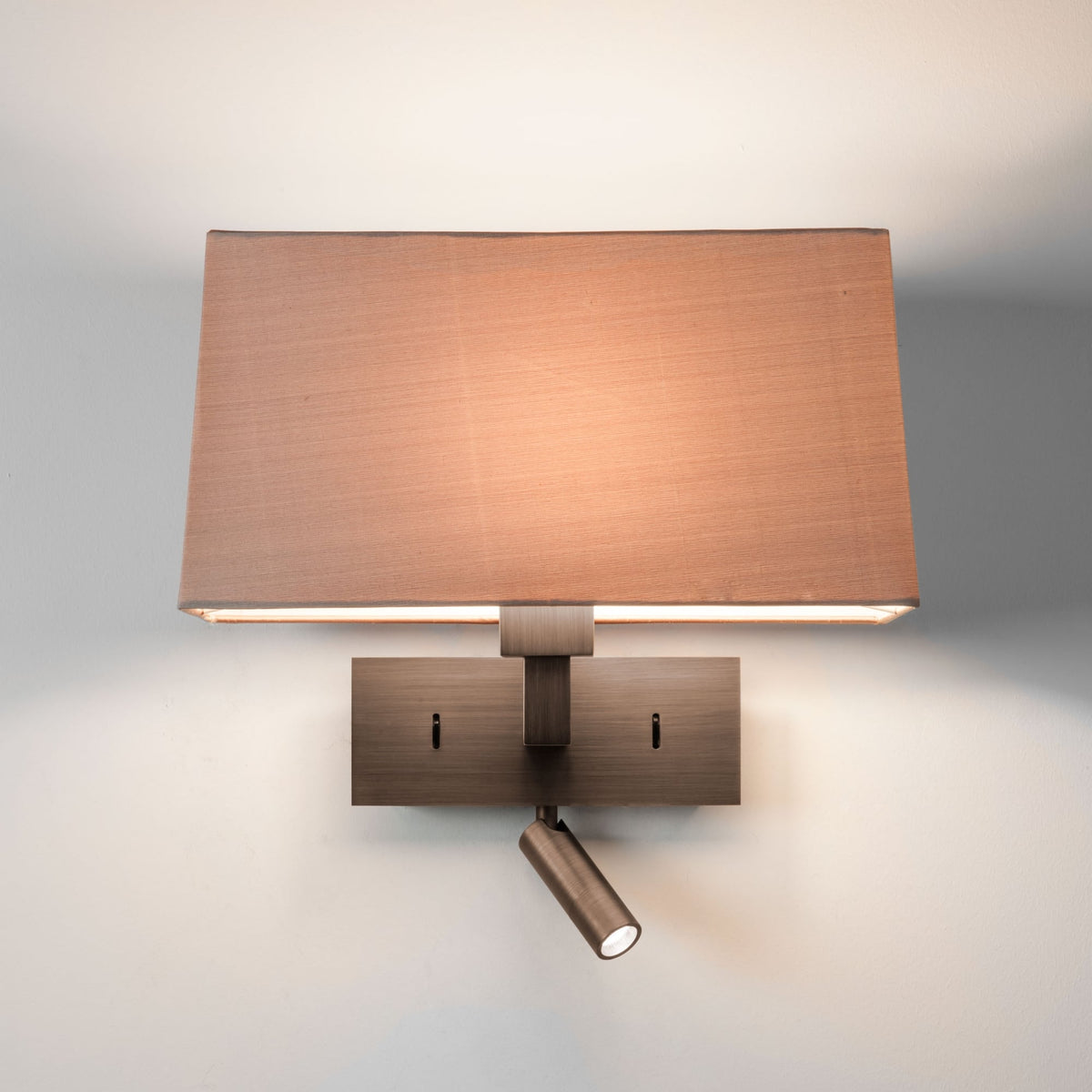 Wall-mounted lamp with a brown shade and additional spotlight on a light gray background