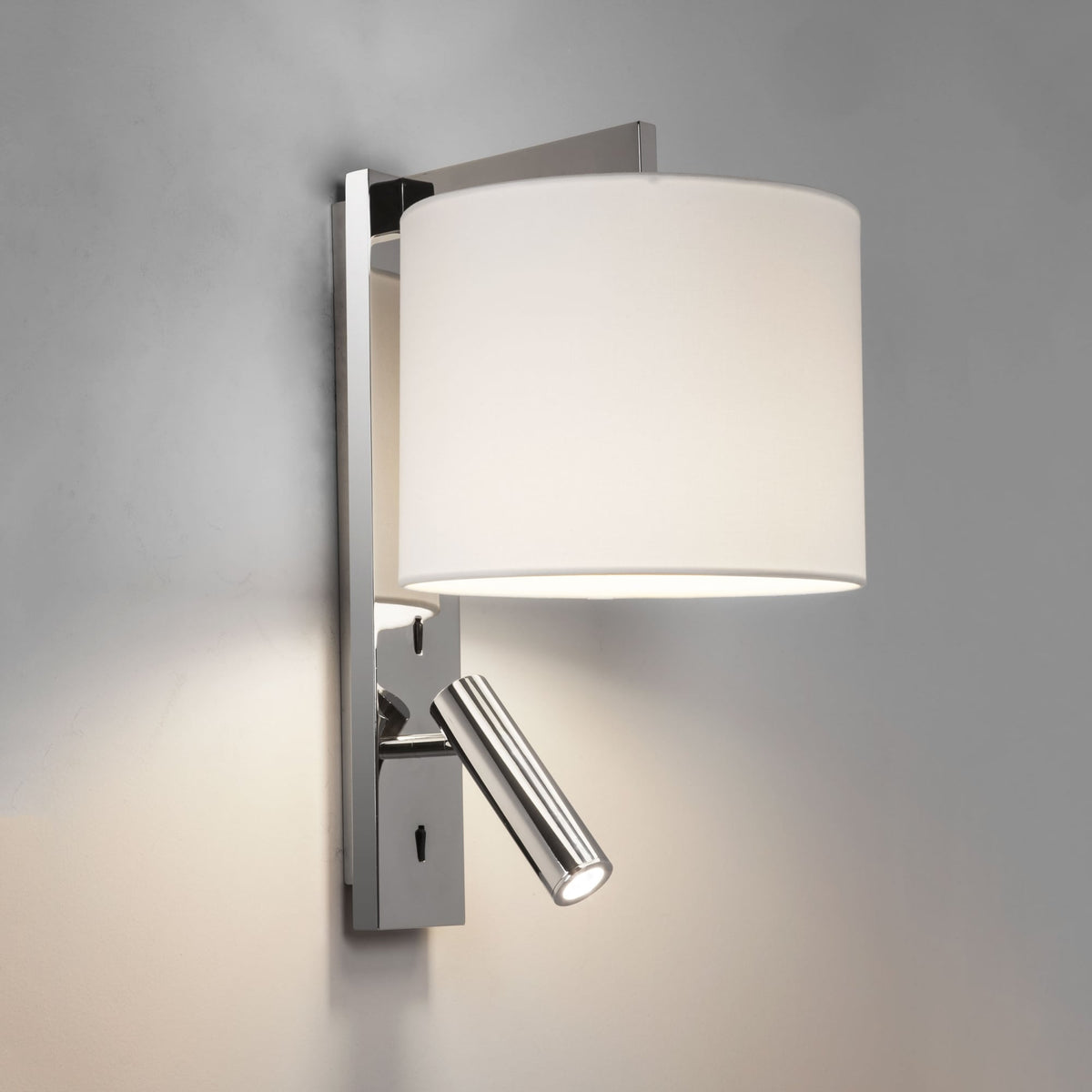 Chrome wall light with a white fabric shade and an adjustable reading light