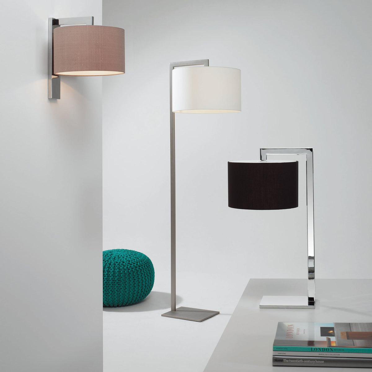 Three lamps and a teal knitted pouf. A wall lamp, a floor lamp, and a table lamp with different shades