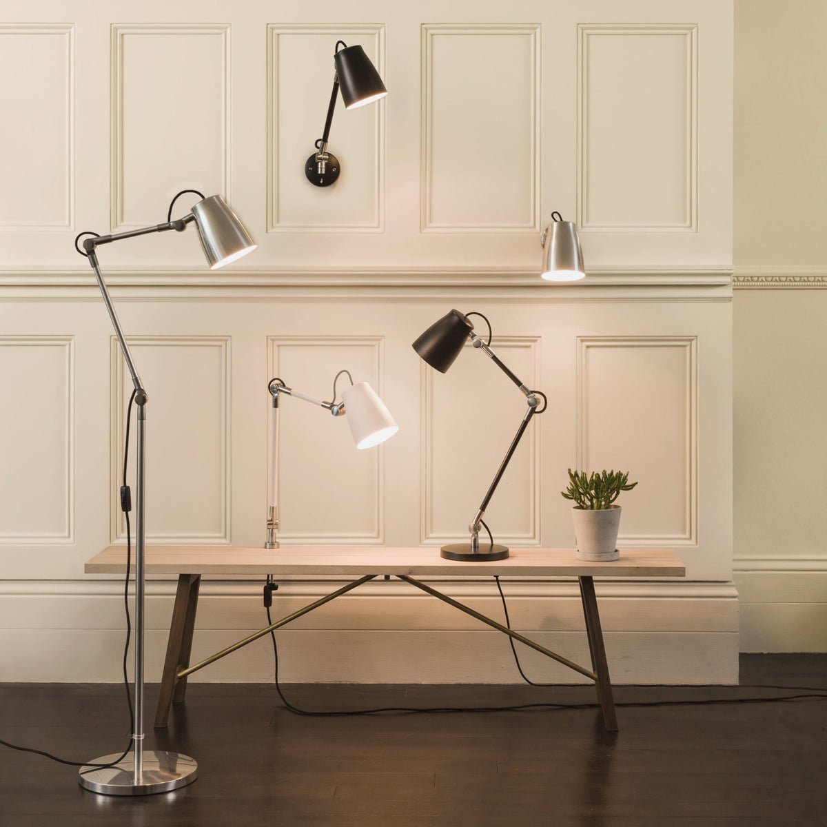 Five adjustable lamps in various styles and colors, including floor, wall, and table models