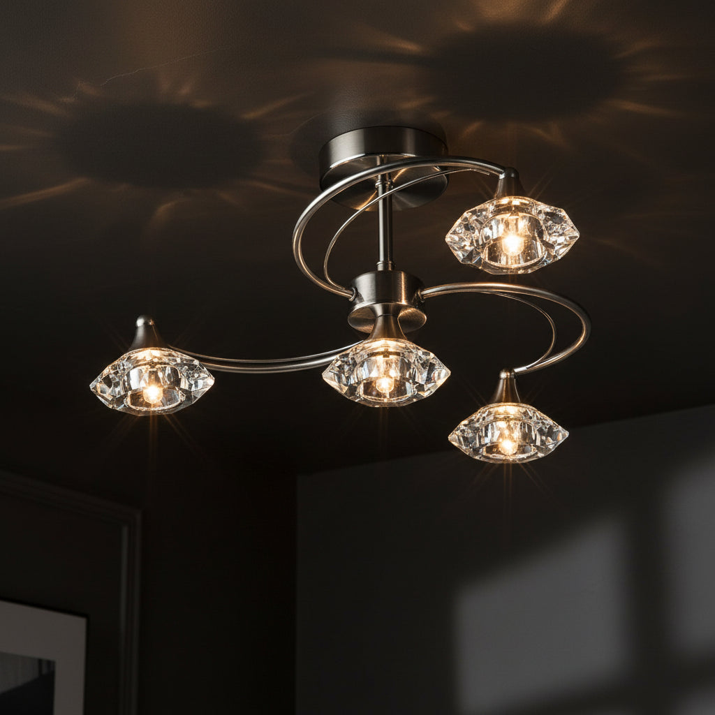 Brushed chrome ceiling light with four clear faceted glass shades.