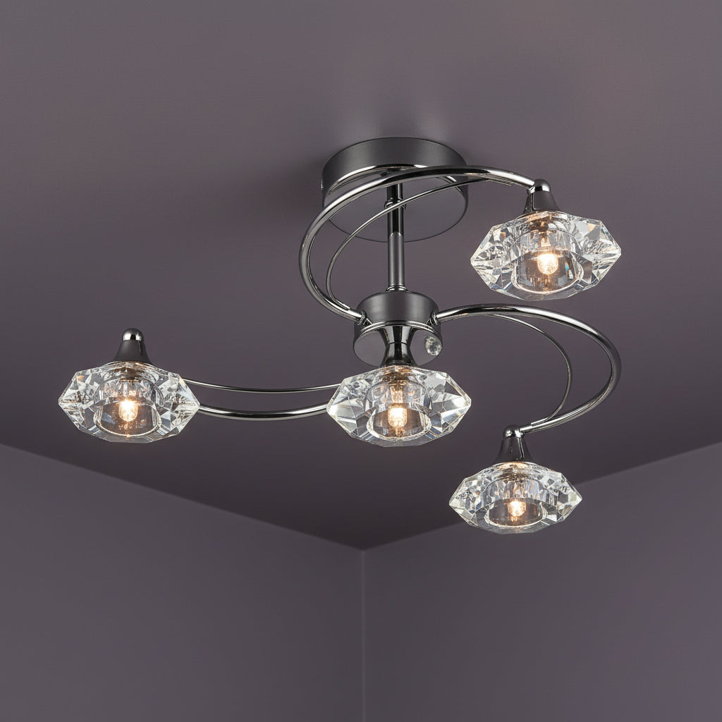 Chrome ceiling light with four curved arms, each holding a faceted crystal shade with a glowing bulb.