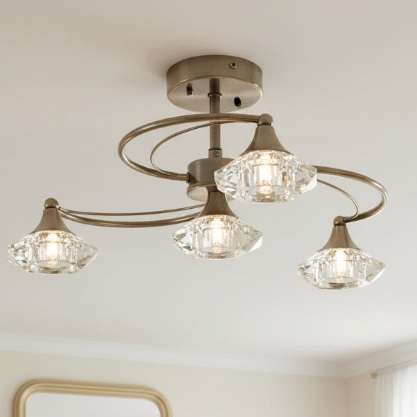 Bronze ceiling light with four curved arms, each holding a faceted crystal shade with a bulb inside.