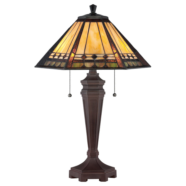 A table lamp featuring a stained-glass shade with geometric patterns and a dark base.