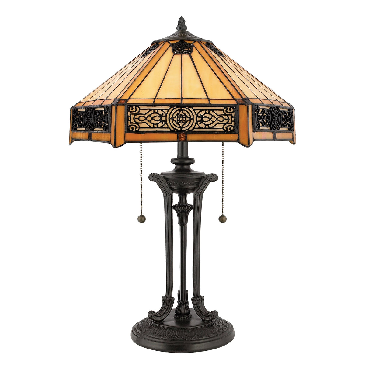 A close-up of a traditional table lamp with a patterned stained-glass shade.