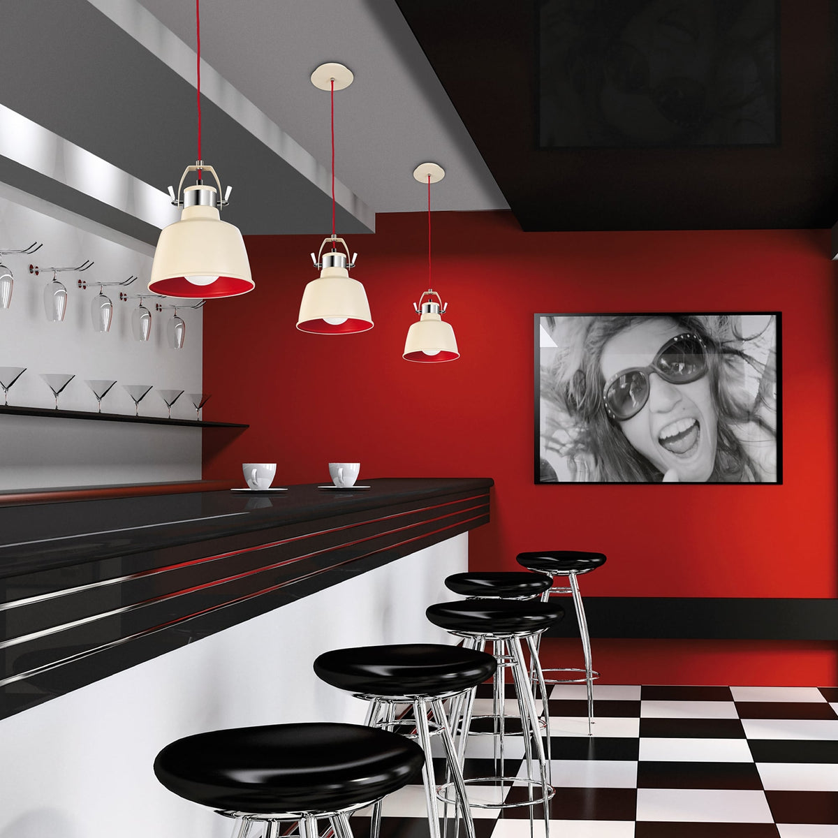 A stylish bar area featuring three cream and red pendant lights over a black and white bar.