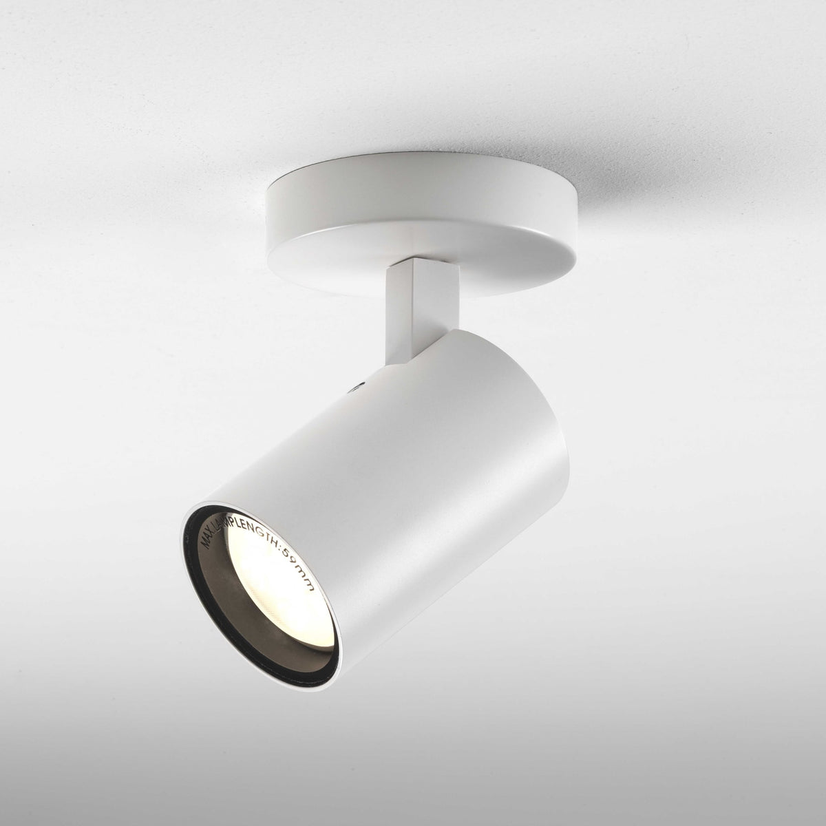 White cylindrical ceiling spotlight with a black inner rim and visible bulb