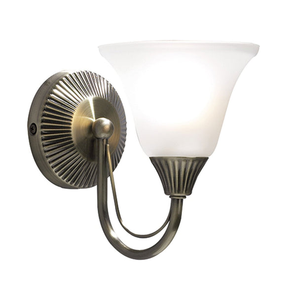 A classic antique brass wall light with a frosted bell-shaped glass shade.