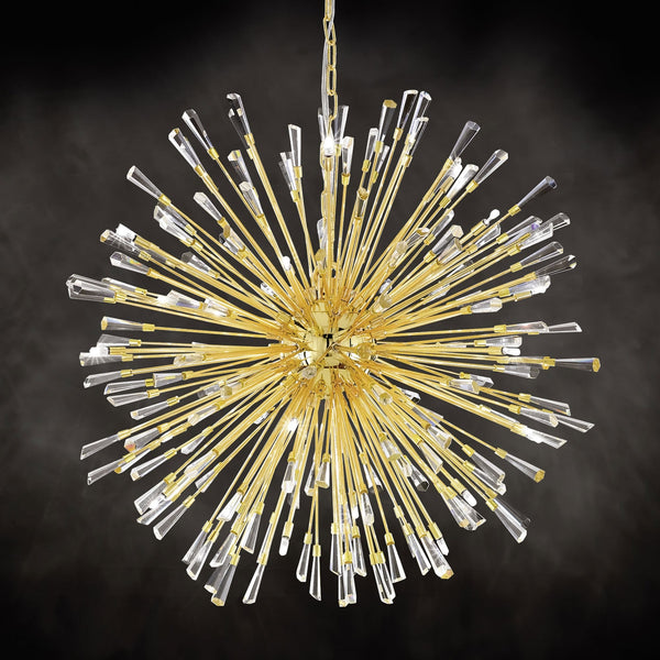 A gold pendant light with crystal rods on a dark background.