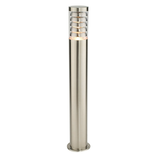 A stainless steel bollard light with a warm glow from its horizontal rings.