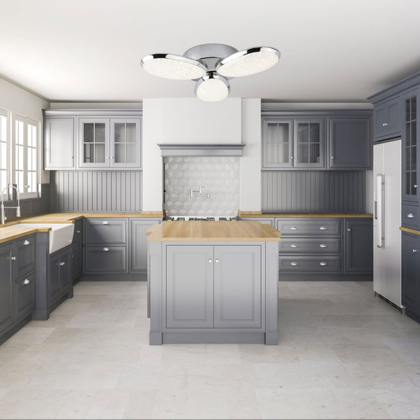 A modern grey kitchen with wooden countertops and an illuminated ceiling light fixture.