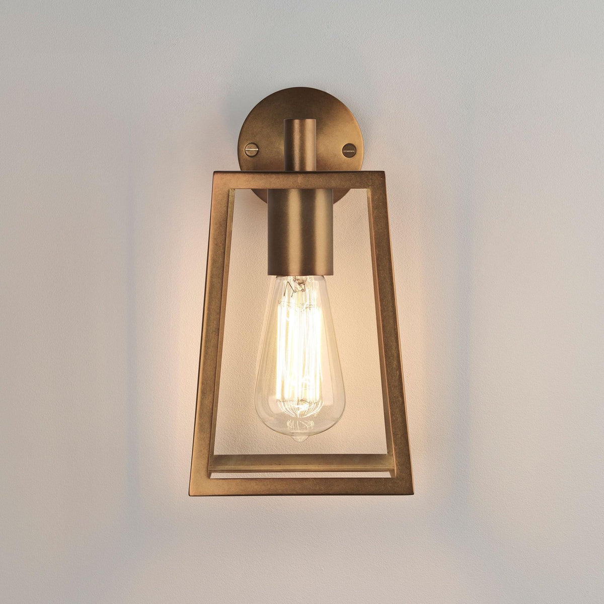 Bronze wall sconce with an exposed Edison bulb