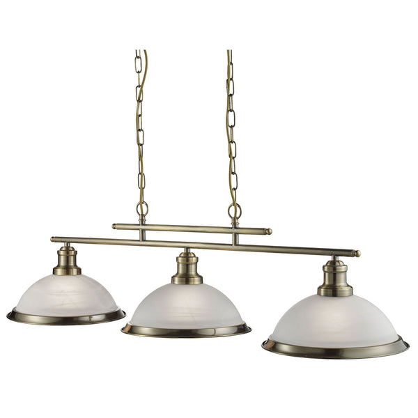 A traditional antique brass billiard light fixture with three frosted glass shades.